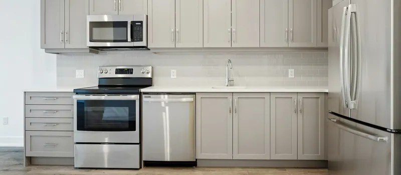 A kitchen with a stainless microwave, range, dishwasher and refrigerator